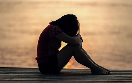 Girl grieving on dock